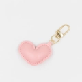 Detailed close-up of a pink heart-shaped leather keychain with a golden metal ring clasp - With Buckle / Pink
