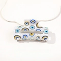 Detailed view of large white hair claw clip with blue evil eye patterns and glossy finish - 8.5cm Square Evil Eye - Model F