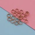 Macro shot of rose gold stainless steel jump rings for DIY jewelry making and crafts - Rose Gold