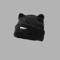 Close-up of black fuzzy cat ear beanie with a metallic plaque and soft plush texture - Black