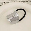 Minimalist silver wavy alloy hair tie with black high-elastic band on ceramic tray - Arched Cloud Silver