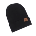 Close-up shot of a black knitted beanie hat featuring a brown leather brand patch. - One Size / Black