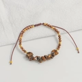 Detail of handmade bohemian bracelet with natural brown stones and adjustable cord - Tiger's Eye