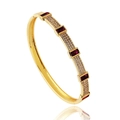 Detailed macro of gold plated bracelet with red rectangular stones and micro zircon pavé - Red