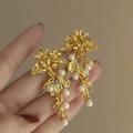 Elegant gold flower branch earrings with white pearls in a delicate botanical design - Gold