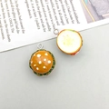 Detailed macro view of two DIY resin hamburger charms with metallic attachment rings - 1Pc Light Brown Resin Mini Burger
