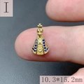 Macro detail of a mini 18k gold crown Virgin Mary pendant with blue gemstone on a fingertip - Style I