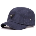 Detail of navy blue five-panel camper hat with textured fabric and triangle leather patch - Adjustable / Navy Blue