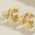 Macro shot of 14K gold plated C-shaped double claw earrings with layered bamboo design - Double Claw Bamboo-14K Gold