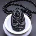 Polished black obsidian necklace with detailed Buddhist deity carving on lotus throne - Ox/Tiger (Akasagarbha) - With Bead Chain
