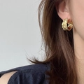 Elegant gold vintage C-shaped earrings with molten texture on female model ear - Lava Texture Irregular C-hoop