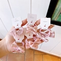 Detail view of five assorted pink fabric bow hair ties on white display cards - 5 Pairs Set / Pink