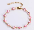 Gold chain bracelet featuring pink Evil Eye enamel charms with adjustable lobster clasp - Pink