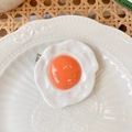 Funny fried egg hair clip featuring a realistic orange yolk and white resin texture - Fried Egg