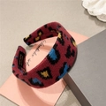 Detail of handmade red leopard print knitted headband with authentic inner woven label - Red