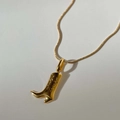 Macro shot of 18k gold plated cowboy boot pendant necklace with detailed textures - Gold Boot Necklace