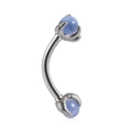 Close-up of stainless steel curved barbell with silver dragon claws holding blue gems - Light Blue