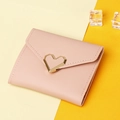 Close-up of pink leather wallet with gold heart buckle and envelope flap detail - Light Pink
