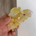Detail of yellow acetate hair claw clip featuring 3D flowers and pink rhinestones - Rapeseed Yellow
