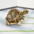 Macro shot of small turtle figurine made of natural unakite crystal and resin - Rhodonite + Gold Foil