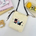Close-up of cream canvas bucket bag featuring cute black cat embroidery and drawstring - Headphone Cat (Cream)