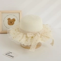 Close-up of cute summer straw hat for girls with lace and polka dot mesh brim - Hat / Cream