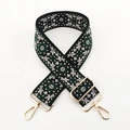 Close-up of geometric embroidered bag strap with premium gold metal adjustment hooks - Black White Green Floral