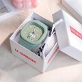 Macro detail of mint green square watch with cartoon elephant dial and silicone strap - Matcha Green