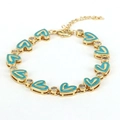 Detail of bohemian gold bracelet with blue enamel hearts and clear zircon stones - Blue