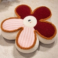 Smiling flower plush cushion in deep red and pink stripes with a soft fleecy texture - Pink Stripe and Red / Small Style