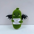 Detail of handmade green crochet emotional support pickle doll with wings and card - Devil Pickle