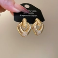 Detailed close-up of gold diamond-encrusted geometric earrings on a display card - Gold / Gold