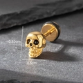 Macro shot of gold skull stud earring with size dimensions on a dark stone background - Punk Skull Head Style (S182)