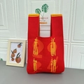 Red knit wrist bag with 2024 Chinese New Year blessings and yellow knitting pattern - Happy New Year Red