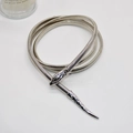 Macro shot of silver snake-shaped metal chain with detailed snake head and tail carvings - Silver