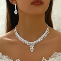 Close-up of bridal rhinestone tassel necklace and matching drop earrings on a model - Silver 205-Vintage Hollow