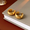 Chunky gold brushed hoop earrings with matte finish on a minimalist book cover - Chunky Matte Brushed Gold Wide Hoop Earrings