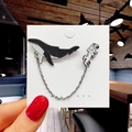 Detail view of cartoon whale and astronaut enamel pins connected by a metal chain - 61*Whale and Astronaut Chain Pin
