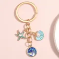 Portachiavi con stella marina e conchiglia dorato con smalto blu e perle - Stella marina Conchiglia Scaglie Ciano