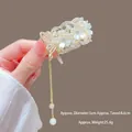 Macro shot of a floral pearl hair claw with tassels and detailed size specifications - M35 White Five-petal Flower