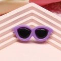 Miniature purple doll sunglasses on a pink geometric display stand for DIY crafts - Deep purple