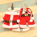 Christmas silverware holder set with Santa style mini jacket and pants on a dinner plate - Plastic Button Top and Pants Set