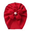 Detailed view of red toddler turban hat featuring a large fabric flower with pearl center - Red