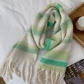 Winter scarf with green and white stripes and fluffy tassels on white bedding - Bright Green