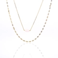 Detail of double-layer titanium necklace with pink raw stone pendant and gold lip chain - Rose Quartz