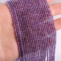 Strand of 2mm to 3mm small round natural amethyst beads held by hand for DIY jewelry - Amethyst