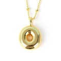 Detailed view of a thick gold donut pendant on a beaded chain necklace for men and women - Letter O