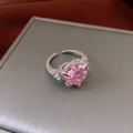 Close-up of heart-shaped pink gemstone ring with zircon pavé on a jewelry box - Heart Style / Silver-Pink