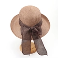 Detail of light brown straw hat with a large dark brown bow on a wooden stand - M (56-58cm) / Khaki