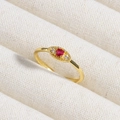 Macro shot of gold ring with oval red gemstone and white zircon accents on fabric - Red Oval Zircon (款式2)